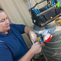 technician checking outdoor ac unit