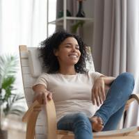 woman sitting in a chair happy