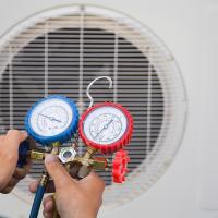 person checking refrigerant lines of an hvac