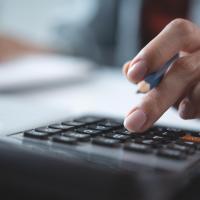 Woman using their calculator