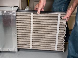 man changing his hvac's system's filter