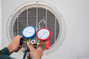 person checking refrigerant lines of an hvac