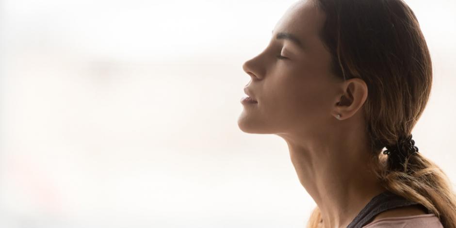 woman breathing in clean air at home