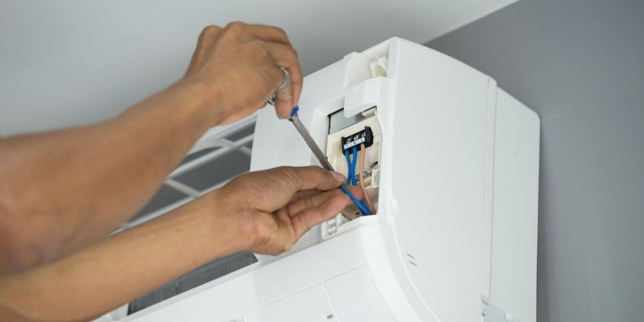 technician installing ac inside home