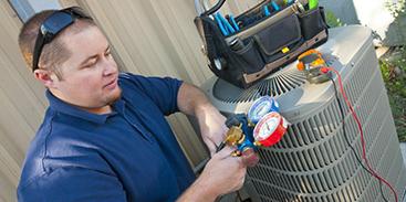 technician checking outdoor ac unit