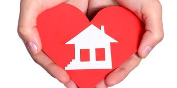 hands holding heart and house, dream home