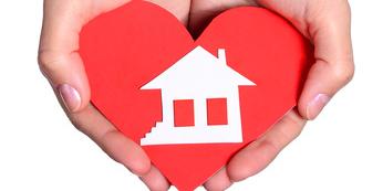 hands holding heart and house, dream home