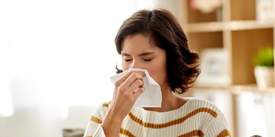 woman sneezing with allergies