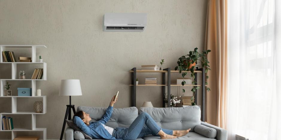 woman laying on couch using a an ac