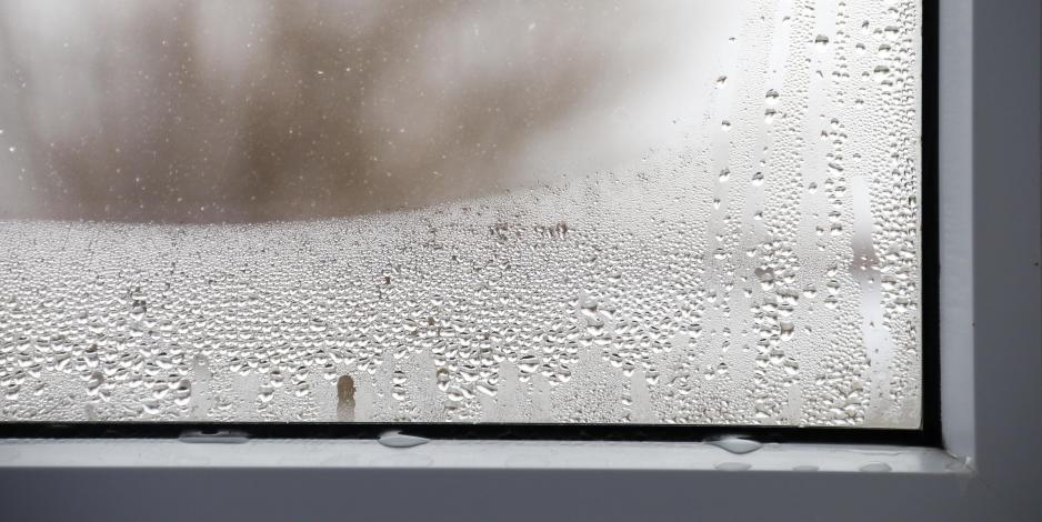 Water droplets on home window from indoor humidity
