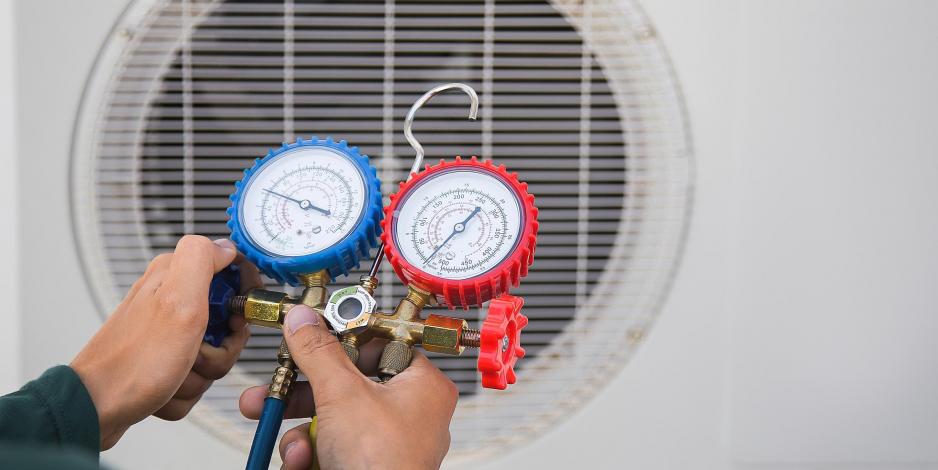 person checking refrigerant lines of an hvac